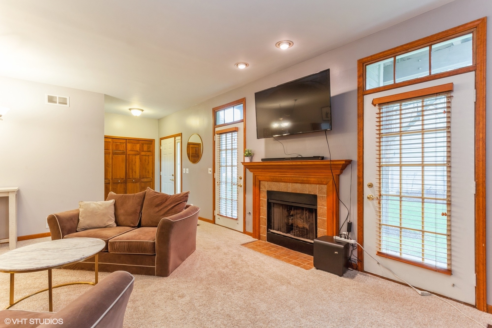 910 Prospect Court, Unit 910 Naperville, IL 60540 - Photo 12 of 17 a living room with furniture a flat screen tv and a fireplace