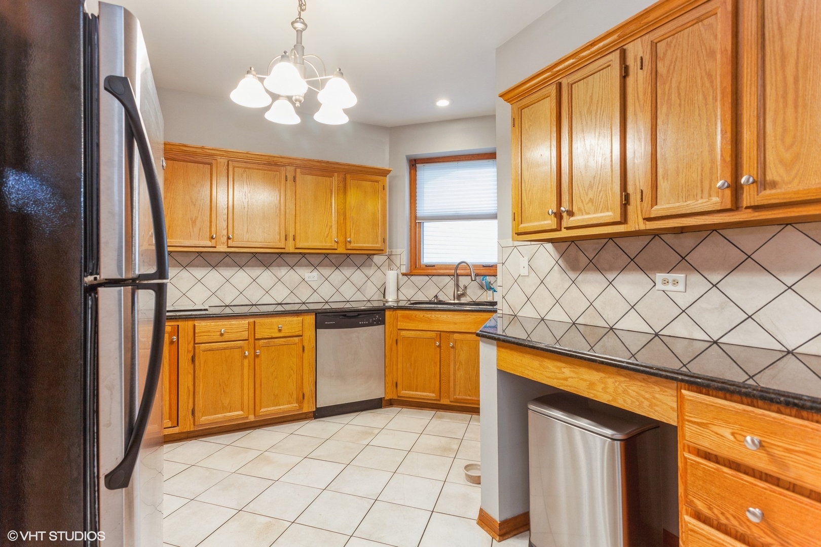 910 Prospect Court, Unit 910 Naperville, IL 60540 - Photo 4 of 17 a kitchen with stainless steel appliances granite countertop a sink and a refrigerator