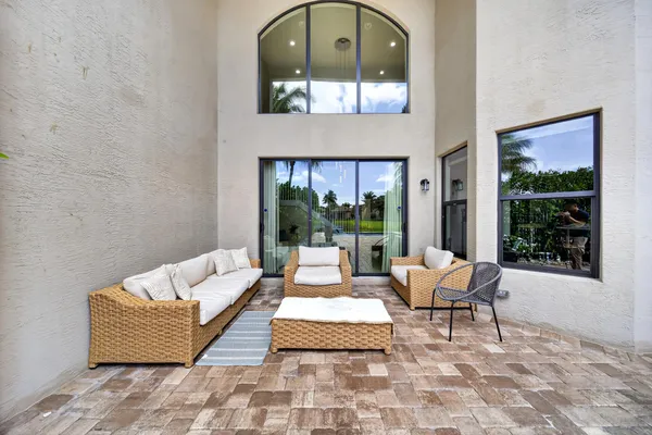 a view of a patio with a table chairs and a small yard