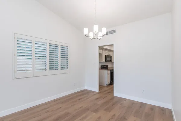 a view of an empty room and wooden floor