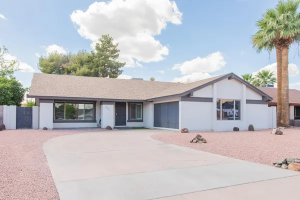 a front view of a house with a yard and a garage