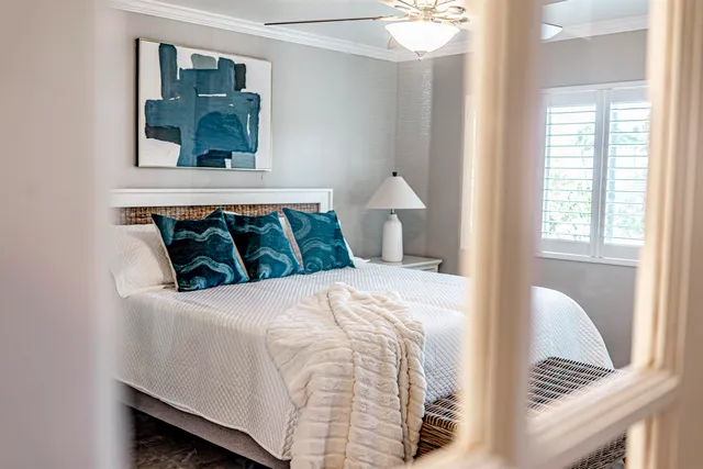 a bedroom with bed and windows