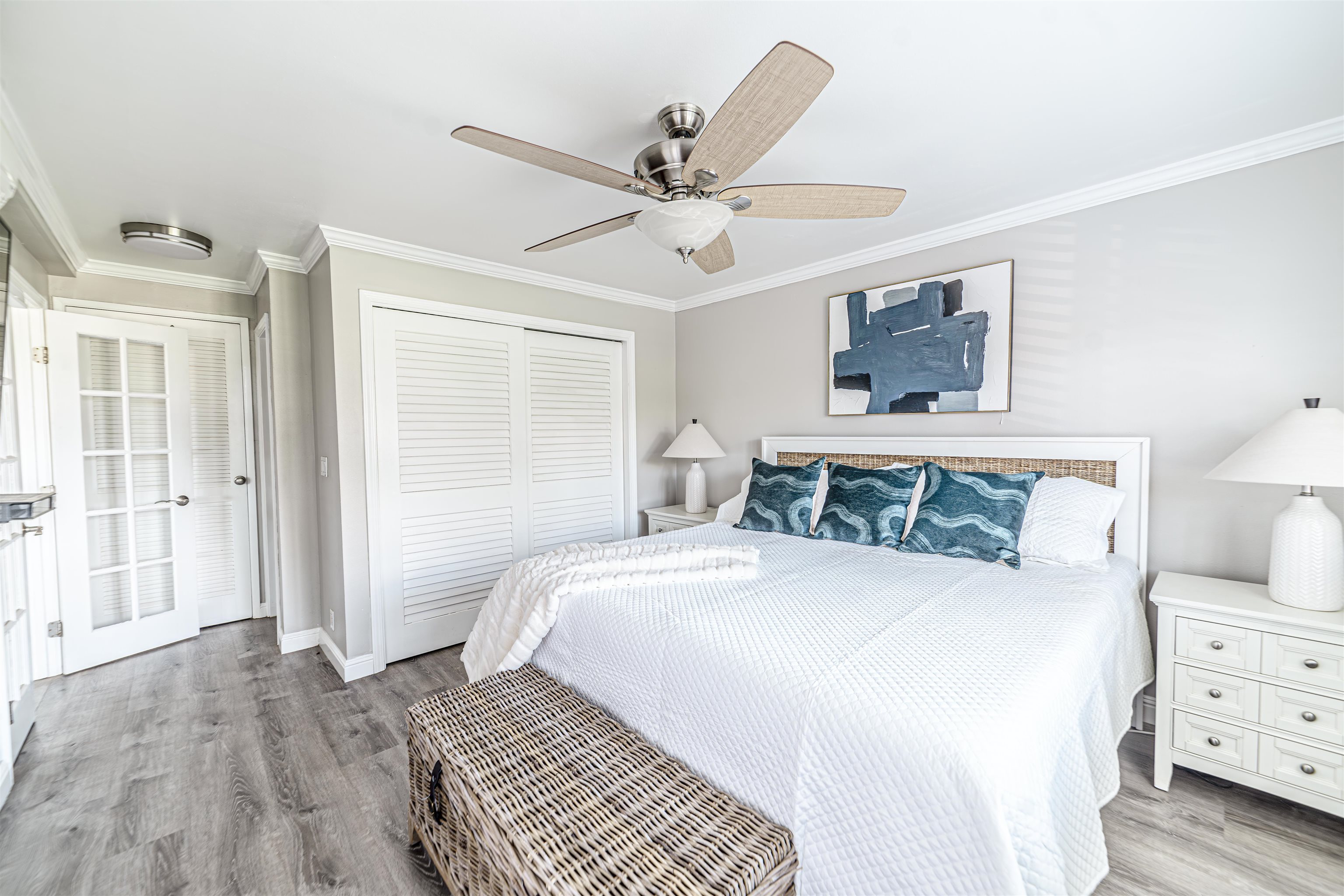 760 South Kihei Road, Unit 202 Kihei, HI 96753 - Photo 14 of 31 a bedroom with a large bed and a chandelier