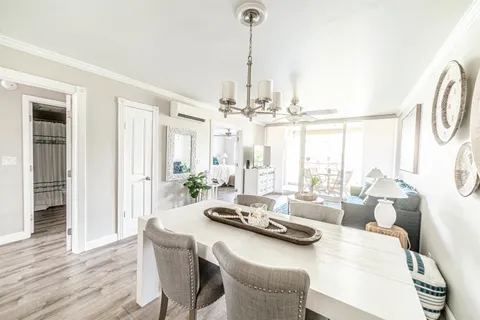 a living room with furniture and a chandelier