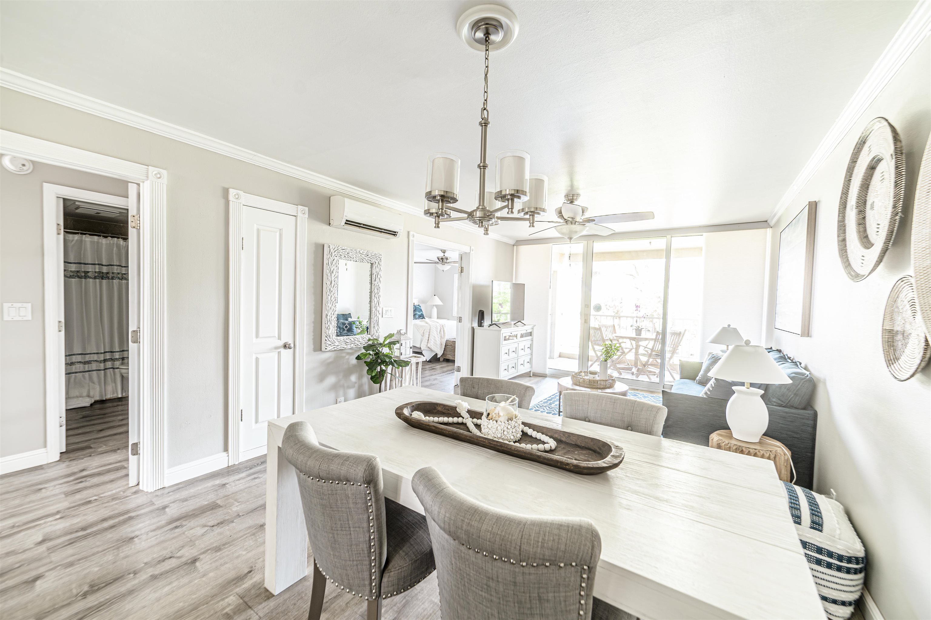 760 South Kihei Road, Unit 202 Kihei, HI 96753 - Photo 3 of 31 a living room with furniture and a chandelier