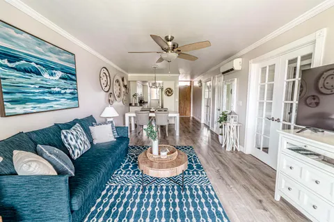 a living room with furniture and a dining table