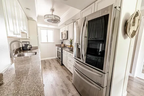 a kitchen with counter top space cabinets and stainless steel appliances