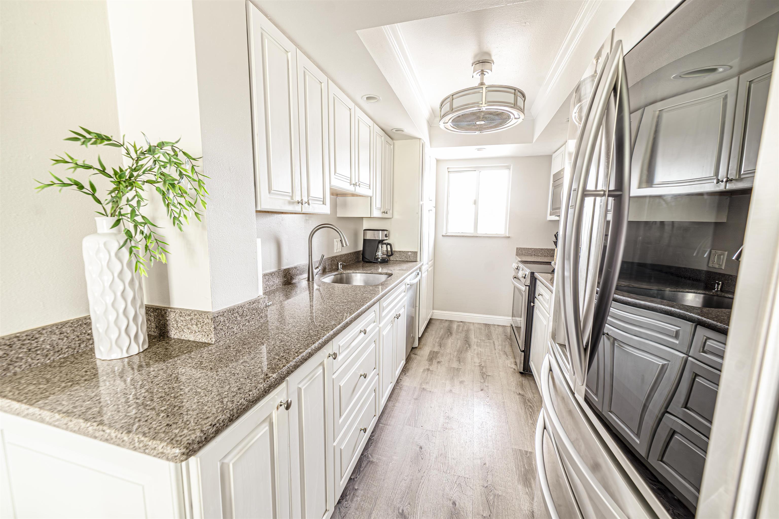 760 South Kihei Road, Unit 202 Kihei, HI 96753 - Photo 9 of 31 a kitchen with counter top space cabinets and stainless steel appliances