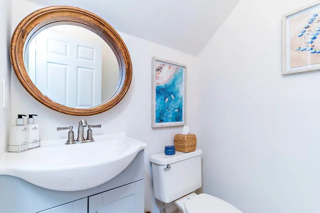 a bathroom with a sink a mirror and a toilet