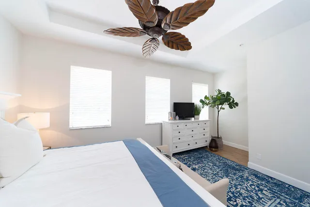 a bedroom with a bed dresser and a window