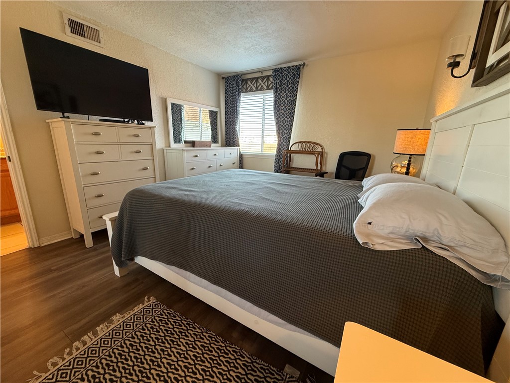 14428 Compass Street, Unit 101 Corpus Christi, TX 78418 - Photo 11 of 16 a bedroom with a bed and a flat screen tv