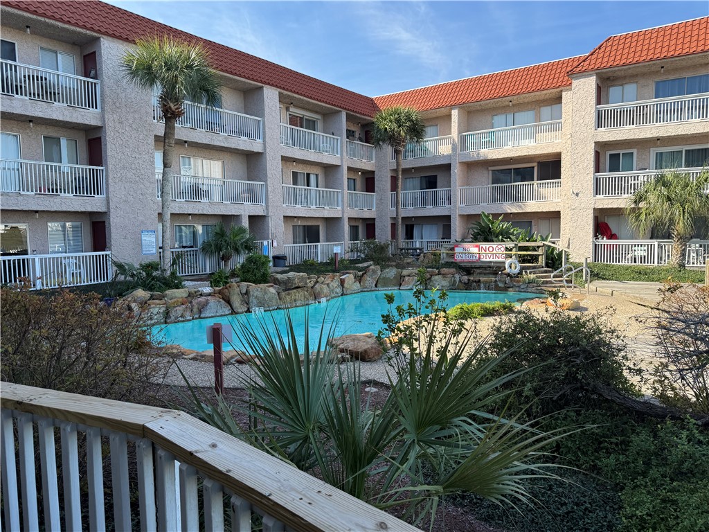 14428 Compass Street, Unit 101 Corpus Christi, TX 78418 - Photo 2 of 16 a view of a building with garden and sitting area