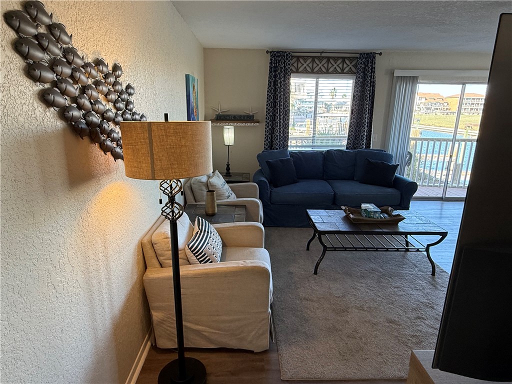 14428 Compass Street, Unit 101 Corpus Christi, TX 78418 - Photo 6 of 16 a living room with furniture and a window