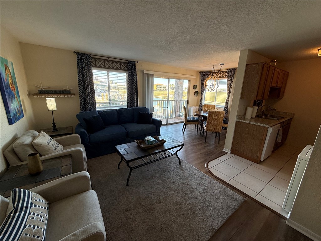 14428 Compass Street, Unit 101 Corpus Christi, TX 78418 - Photo 7 of 16 a living room with furniture rug and window