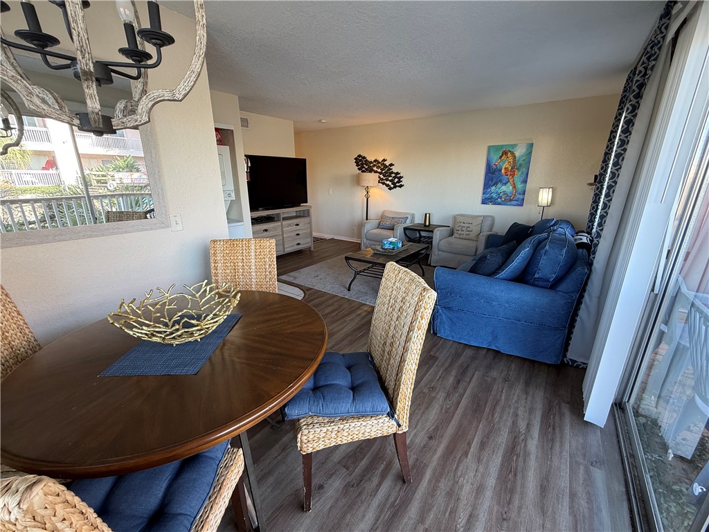 14428 Compass Street, Unit 101 Corpus Christi, TX 78418 - Photo 8 of 16 a living room with furniture and a flat screen tv