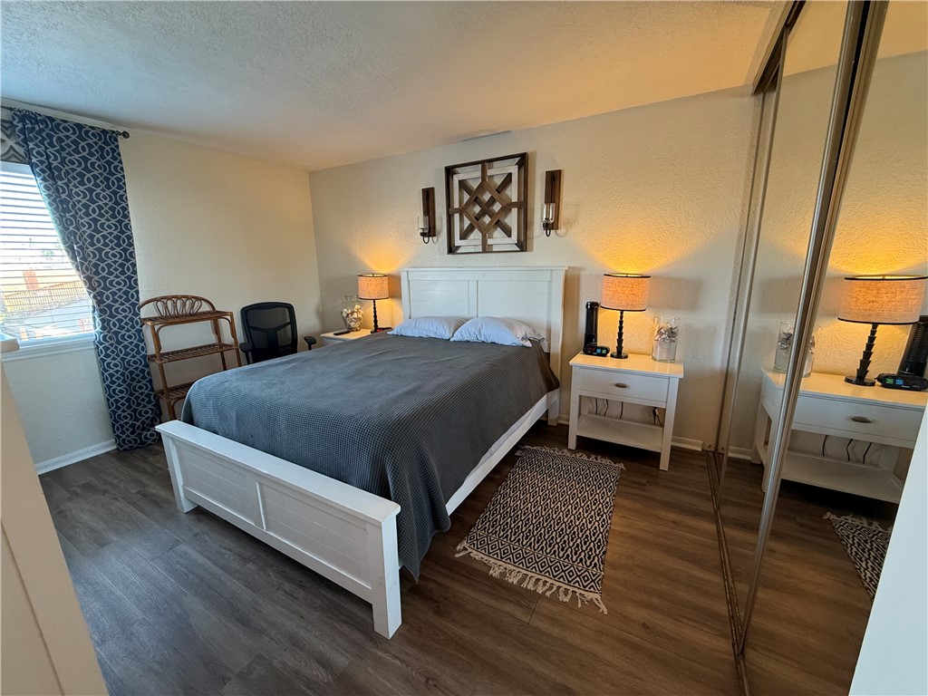 14428 Compass Street, Unit 101 Corpus Christi, TX 78418 - Photo 10 of 16 a spacious bedroom with a bed and a window