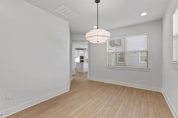 a view of livingroom with chandelier and wooden floor