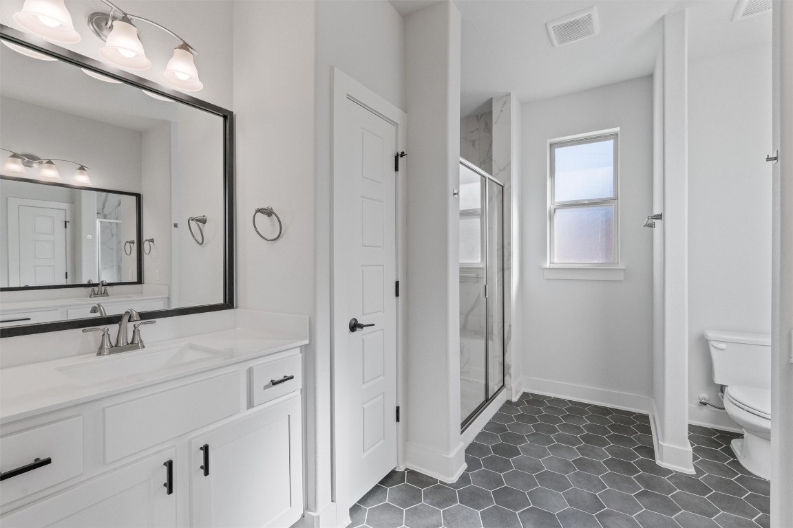 8707 Alderman Dr. Austin, TX 78747 - Photo 14 of 33 a bathroom with a sink and a mirror
