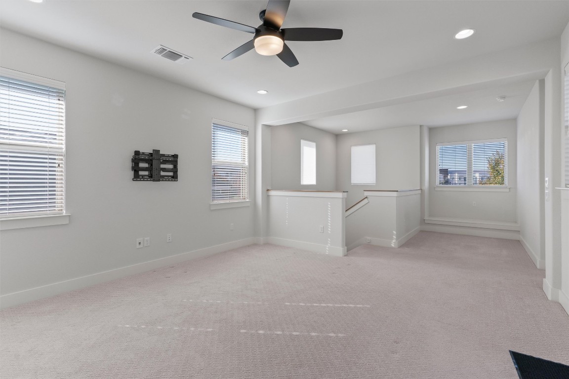 8707 Alderman Dr. Austin, TX 78747 - Photo 20 of 33 a view of empty room with windows and ceiling fan