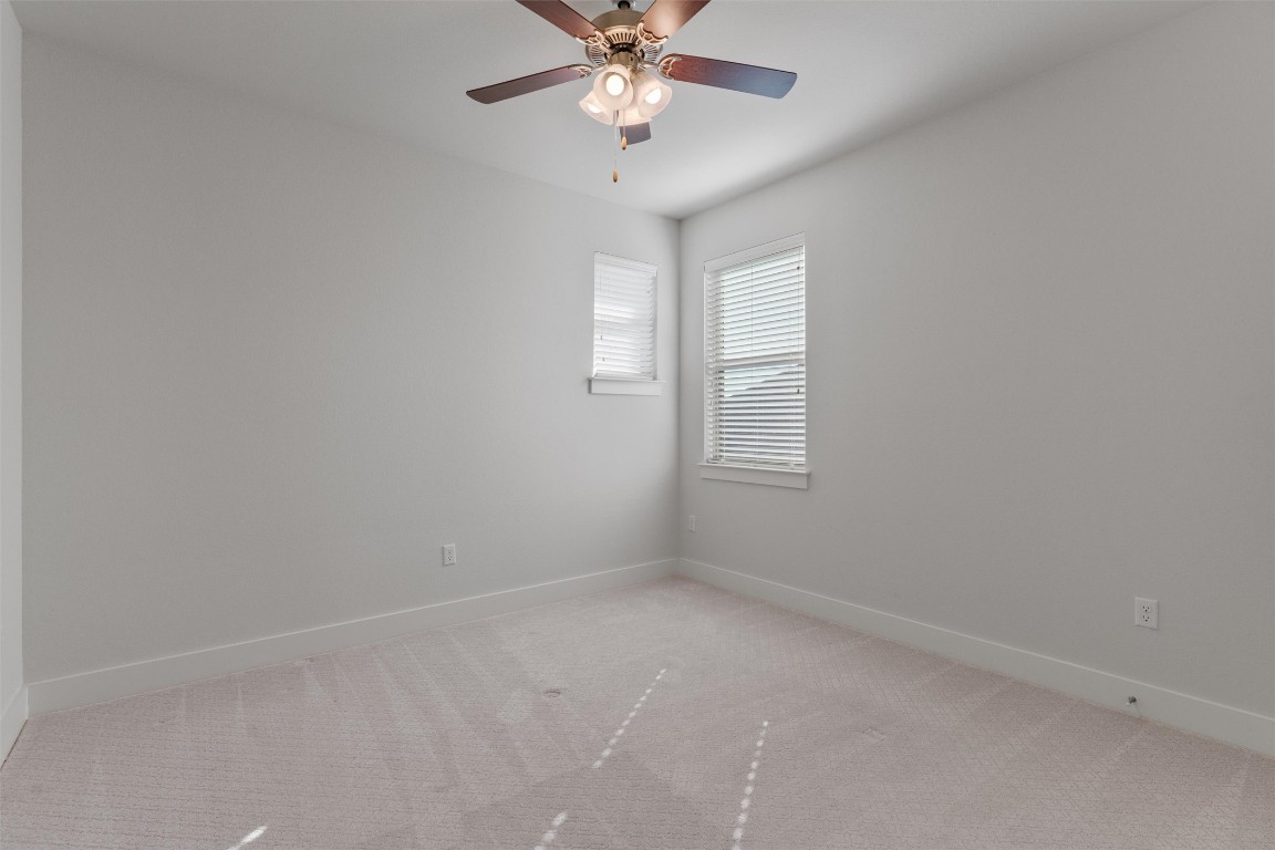8707 Alderman Dr. Austin, TX 78747 - Photo 24 of 33 an empty room with a window and a fan