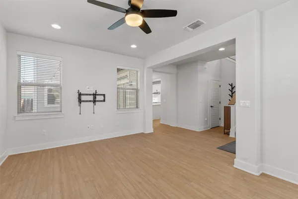 wooden floor in an empty room with a window