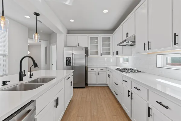 a kitchen with stainless steel appliances granite countertop a sink stove and refrigerator