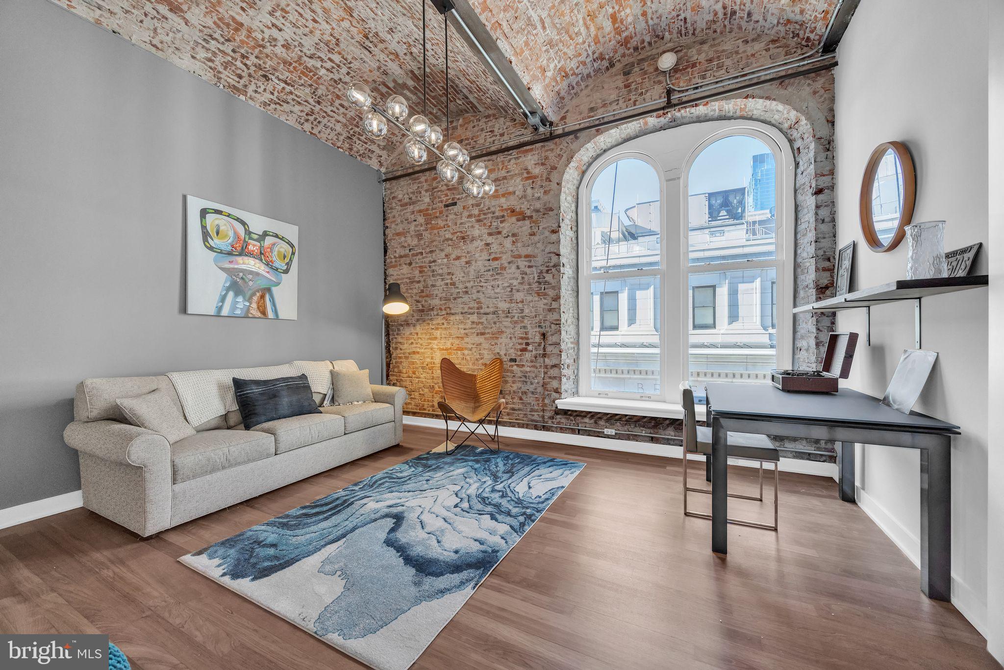 105 South 12th Street, Unit 402 Philadelphia, PA 19107 - Photo 14 of 21 a living room with furniture and wooden floor