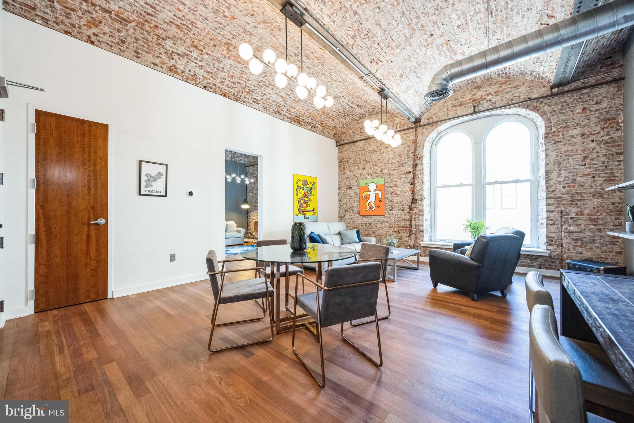 105 South 12th Street, Unit 402 Philadelphia, PA 19107 - Photo 3 of 21 a living room with furniture and wooden floor