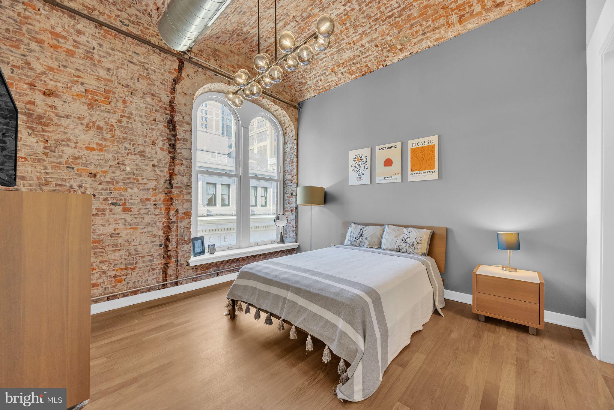 105 South 12th Street, Unit 402 Philadelphia, PA 19107 - Photo 10 of 21 a spacious bedroom with a bed and wooden floor