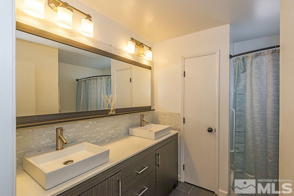 60 Smithridge Park Reno, NV 89502 - Photo 14 of 15 a bathroom with a sink and mirror