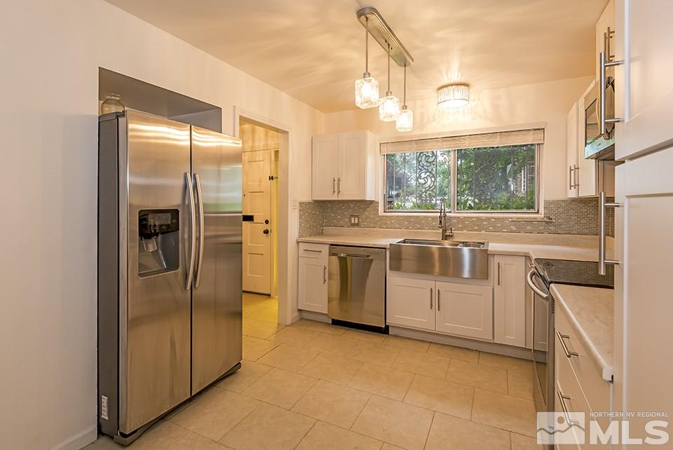 60 Smithridge Park Reno, NV 89502 - Photo 5 of 15 a kitchen with a refrigerator sink and cabinets
