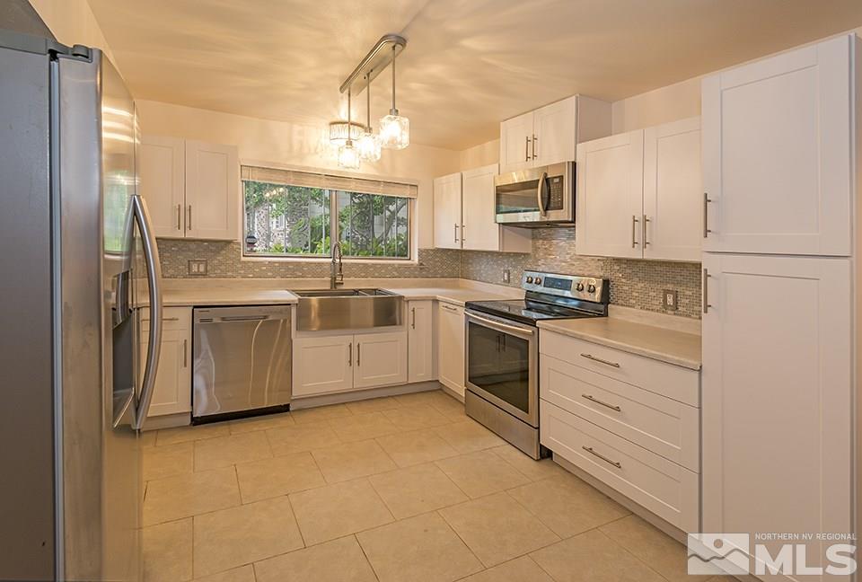 60 Smithridge Park Reno, NV 89502 - Photo 6 of 15 a kitchen with cabinets stainless steel appliances and a window
