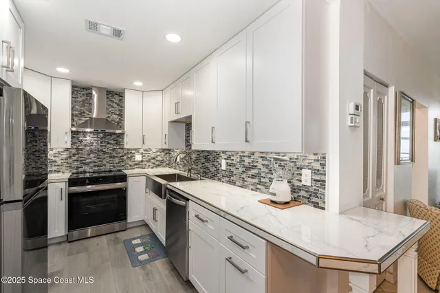 a kitchen with a sink stove and refrigerator