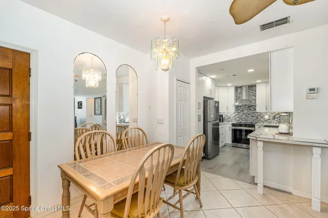 a dining room with furniture and chandelier