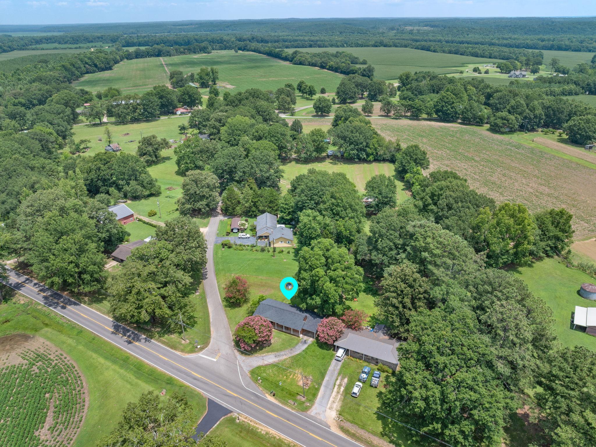 217 Red Bay Road Golden, MS 38847 - Photo 27 of 33 Expansive rural setting featuring a single-story residence with a dark roof and covered porch