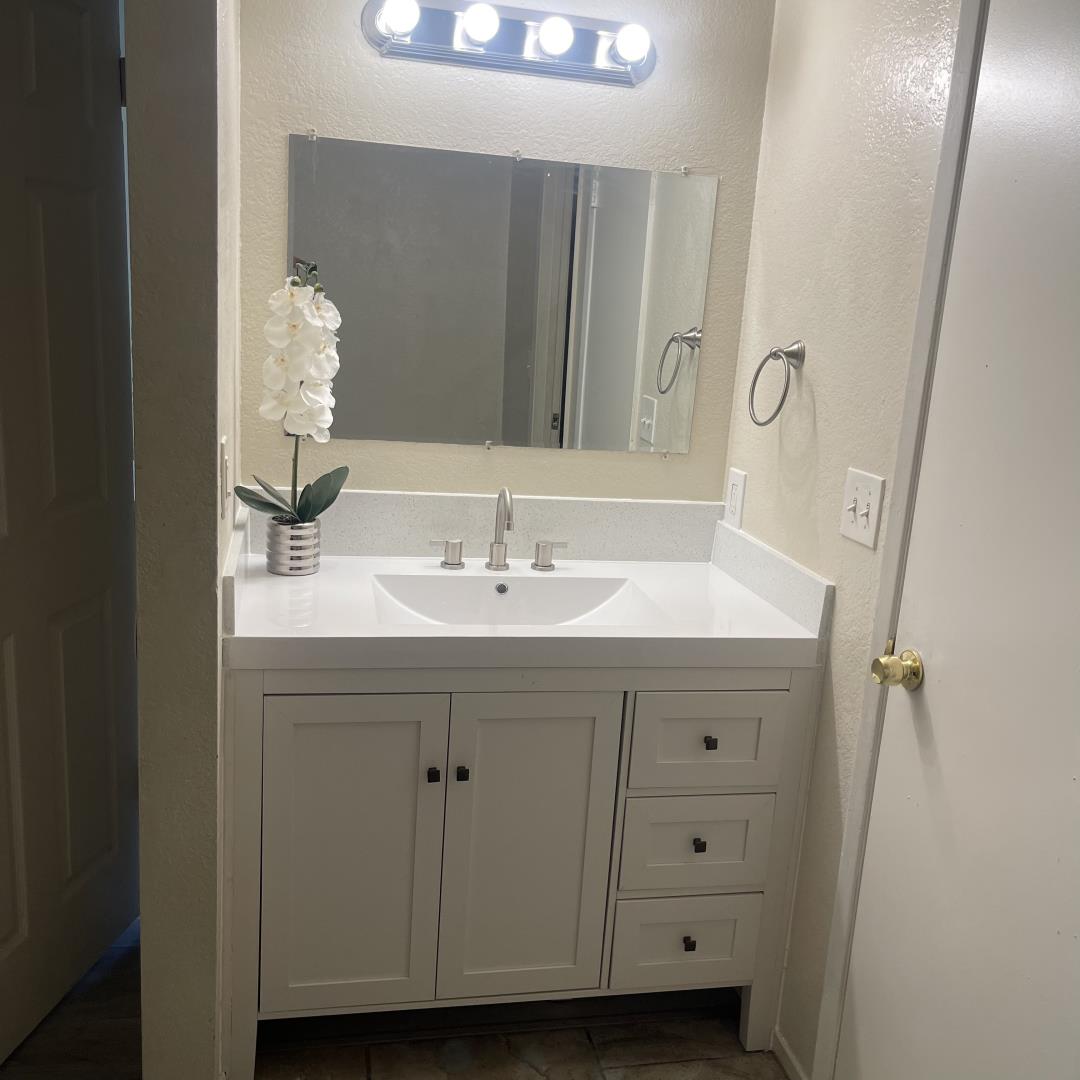 1645 Pyrenees Avenue, Unit 63 Stockton, CA 95210 - Photo 1 of 17 a bathroom with a sink and a mirror