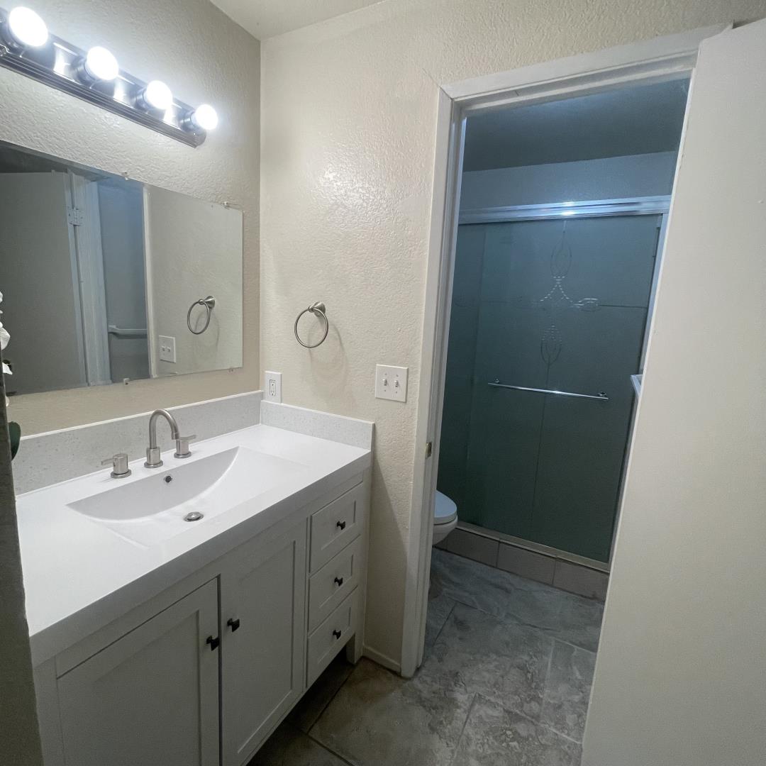 1645 Pyrenees Avenue, Unit 63 Stockton, CA 95210 - Photo 2 of 17 a bathroom with a double vanity sink and a mirror