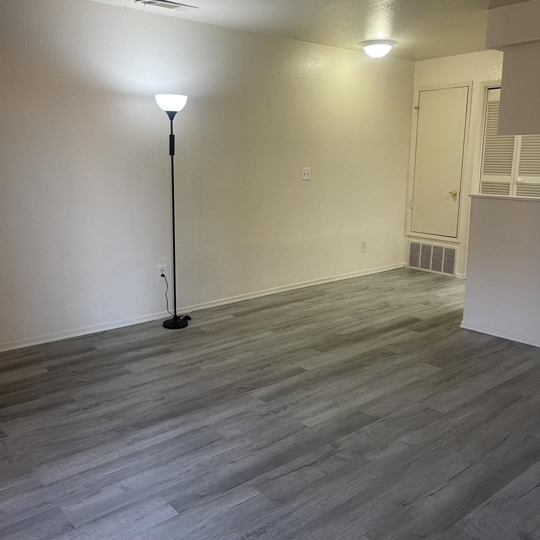 1645 Pyrenees Avenue, Unit 63 Stockton, CA 95210 - Photo 3 of 17 a view of an empty room with wooden floor