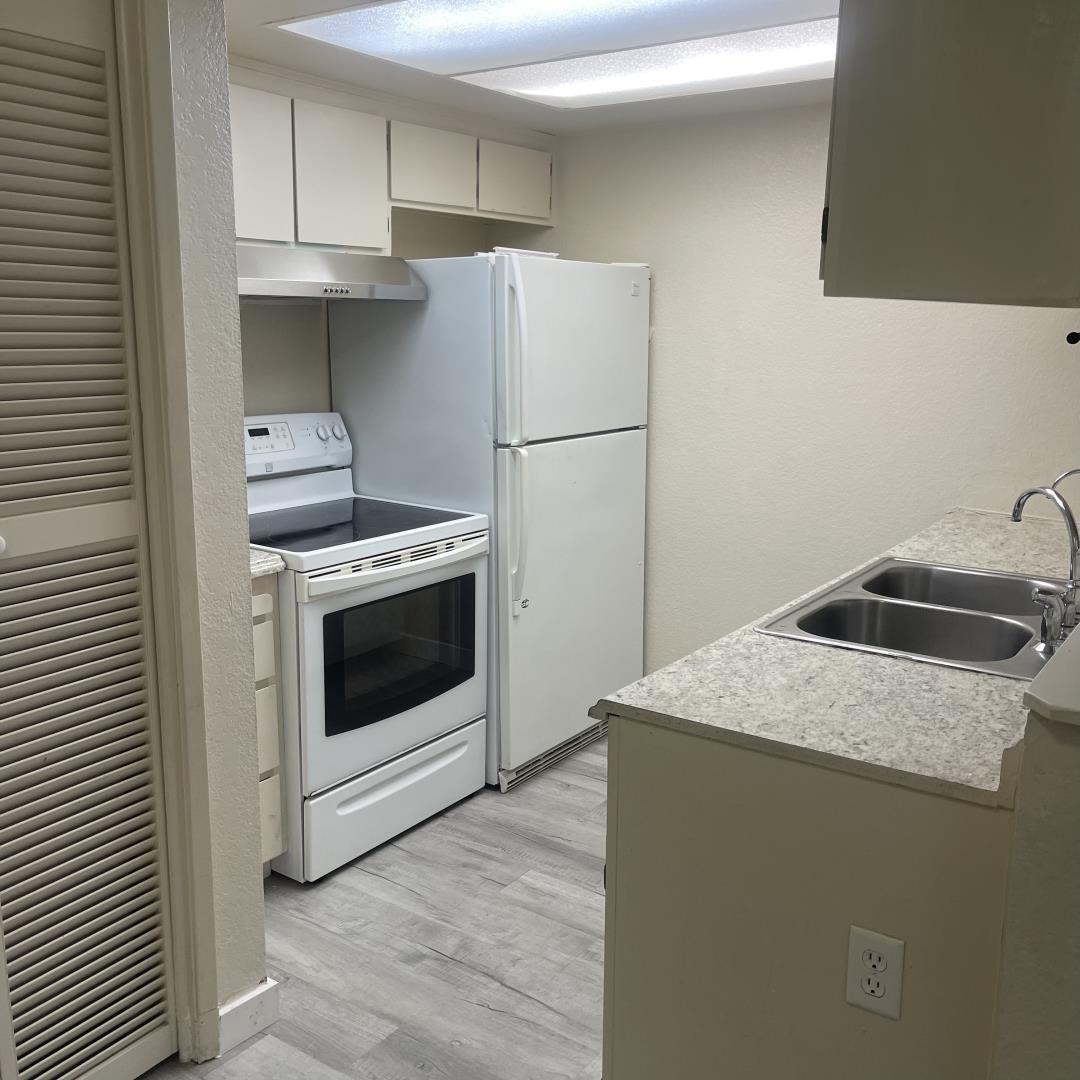 1645 Pyrenees Avenue, Unit 63 Stockton, CA 95210 - Photo 8 of 17 a kitchen with a stove top oven and refrigerator