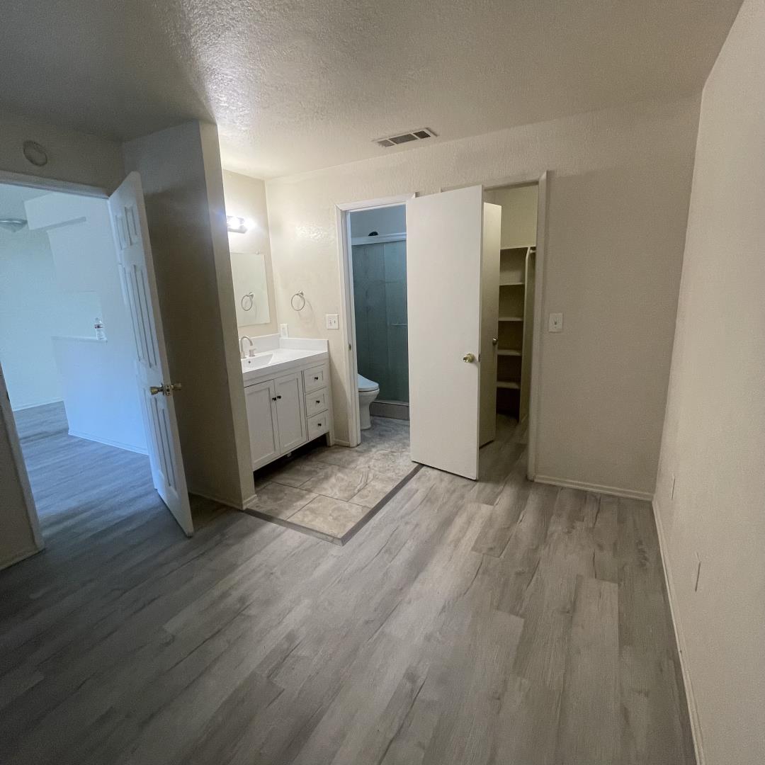 1645 Pyrenees Avenue, Unit 63 Stockton, CA 95210 - Photo 9 of 17 wooden floor in an empty room with a window