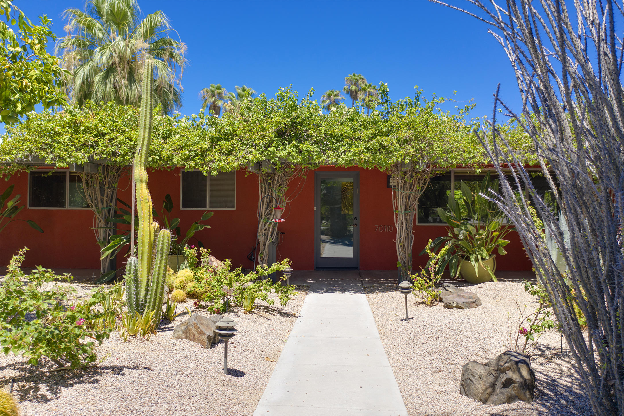 70110 Chappel Road Rancho Mirage, CA 92270 - Photo 21 of 26 a bunch of flowers in front of a house