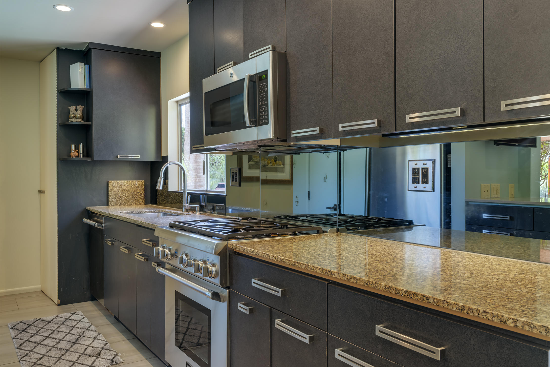 70110 Chappel Road Rancho Mirage, CA 92270 - Photo 9 of 26 a kitchen with stainless steel appliances granite countertop a sink a stove and microwave