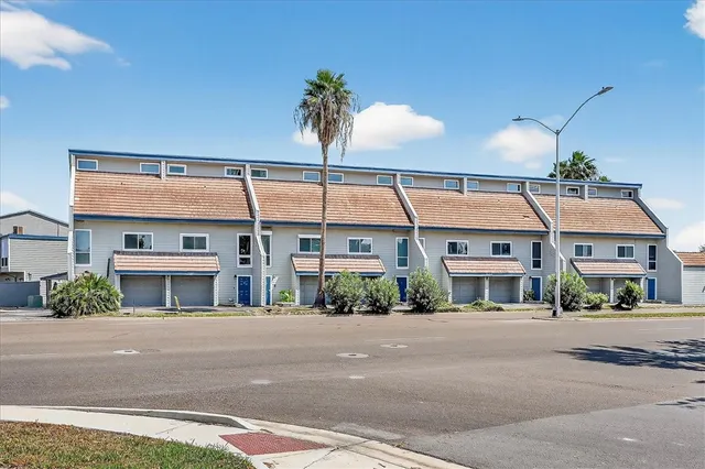 a front view of a building with a garden