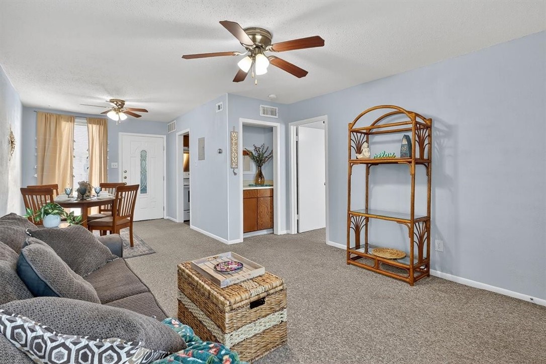 3402 Ocean Drive Corpus Christi, TX 78411 - Photo 14 of 39 a living room with furniture a ceiling fan and a rug