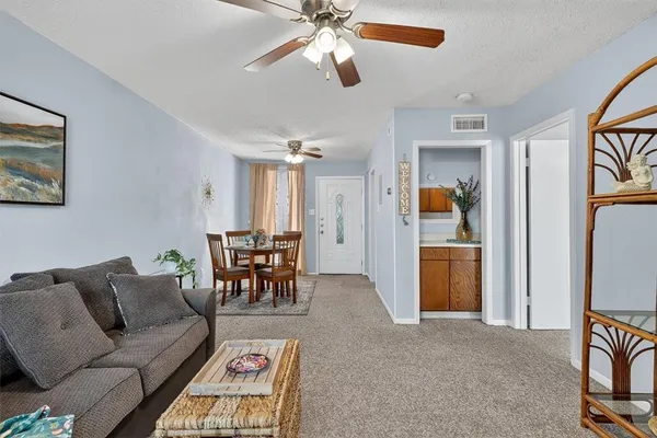 a living room with furniture and a dining table