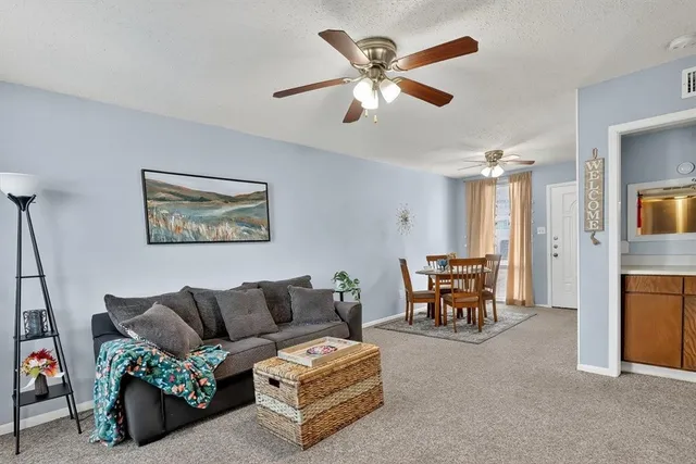 a living room with furniture and a dining table
