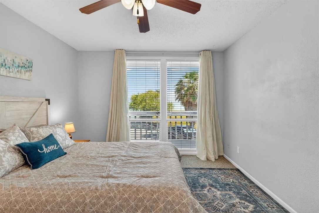 3402 Ocean Drive Corpus Christi, TX 78411 - Photo 19 of 39 a bedroom with a large bed and a window