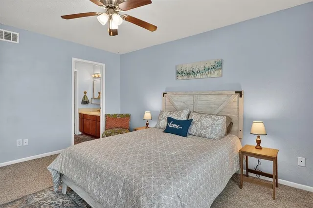 a bedroom with bed and a table