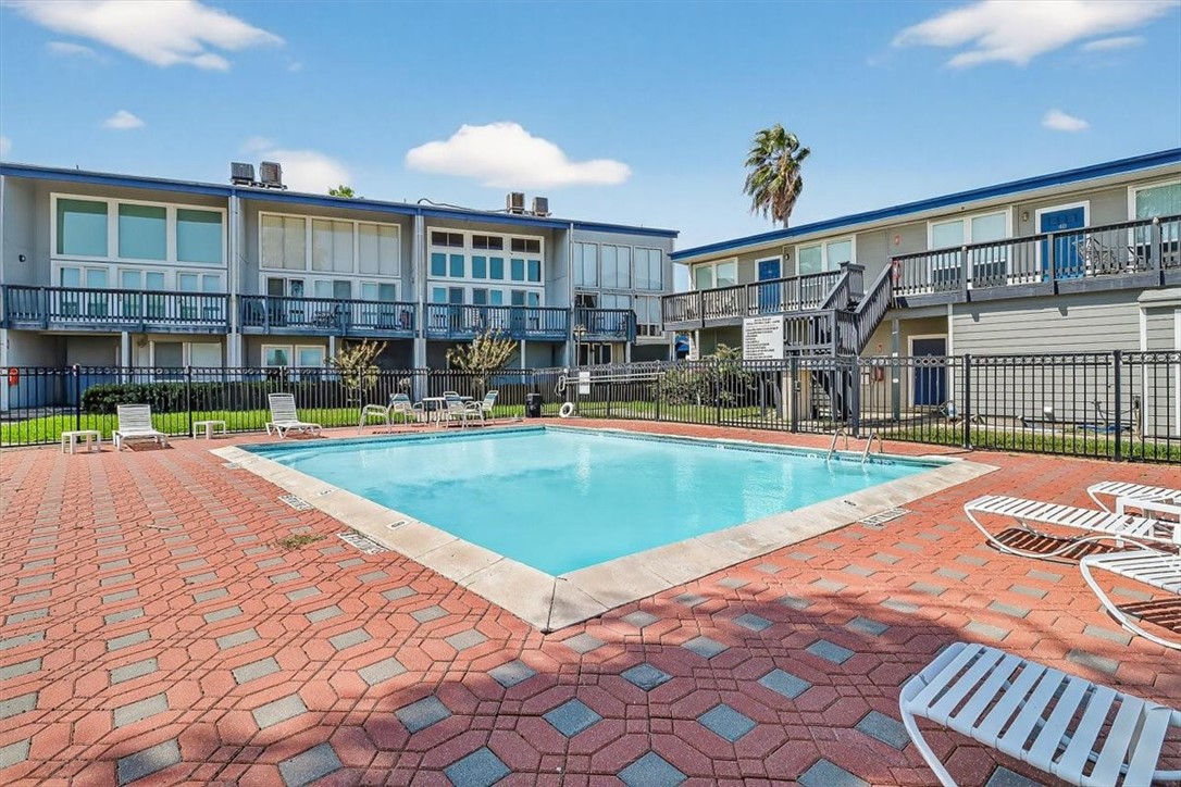 3402 Ocean Drive Corpus Christi, TX 78411 - Photo 28 of 39 a view of a swimming pool with a patio and a yard