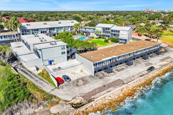 an aerial view of a houses with a big yard